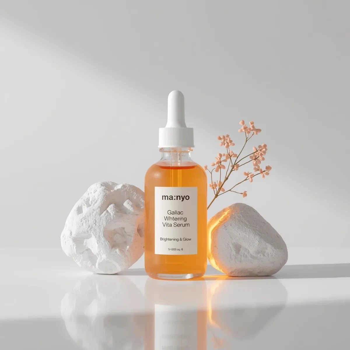 Minimal luxury skincare serum bottle labeled Ma:nyo Galac Whitening Vita Serum placed between white stones with warm sunlight and soft beige studio background. Thumbnail 2