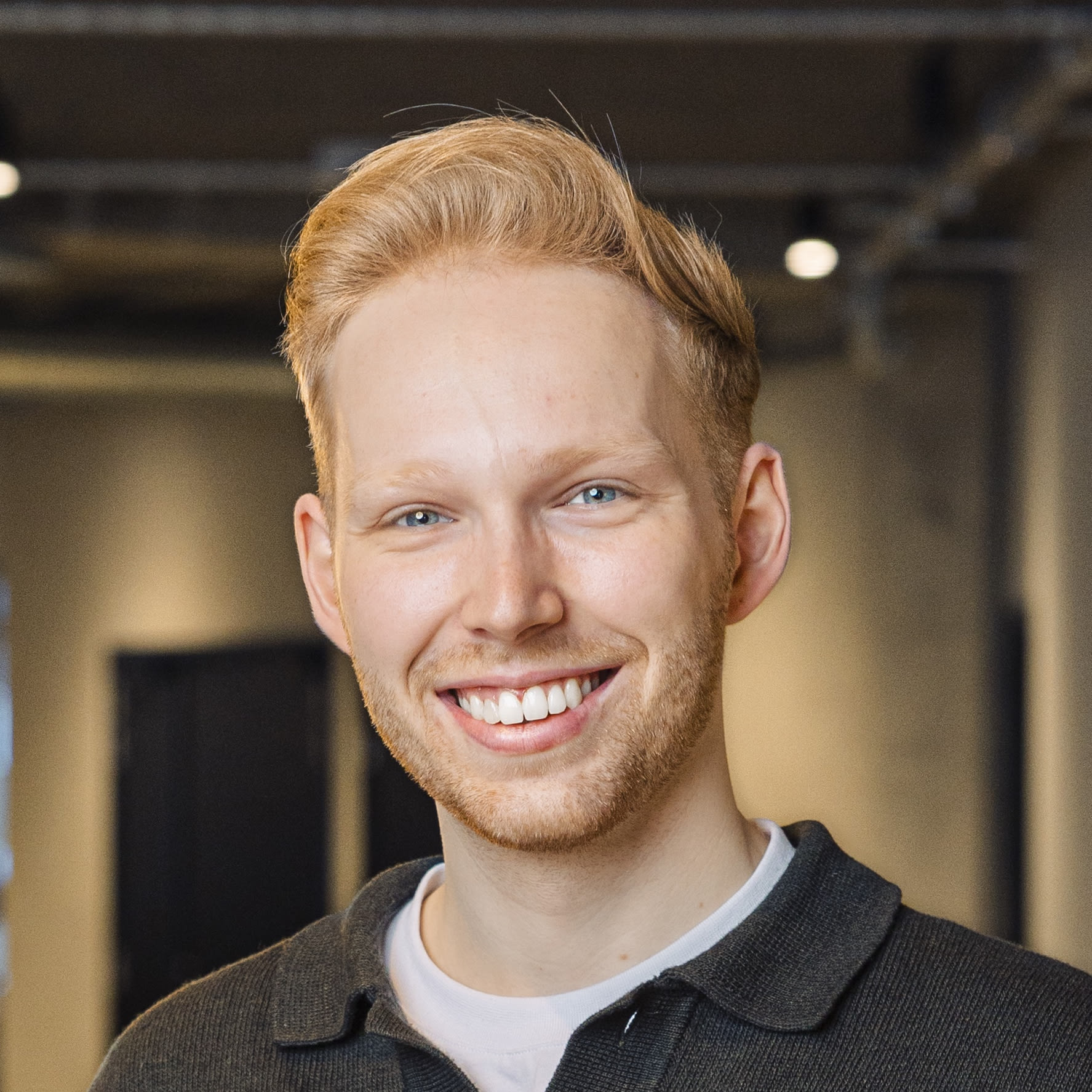 Profile picture of CEO, Frederick Andersen smiling infront of computer screens.