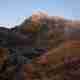 The jagged face of snowdon before sunrise. The mountain has a light dusting of snow on the top.