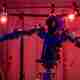 A robot with arms, surrounded by red lights.