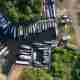 Drone photo looking straight down at a canal boat mooring. There’s dozens of boats all lined up side by side.