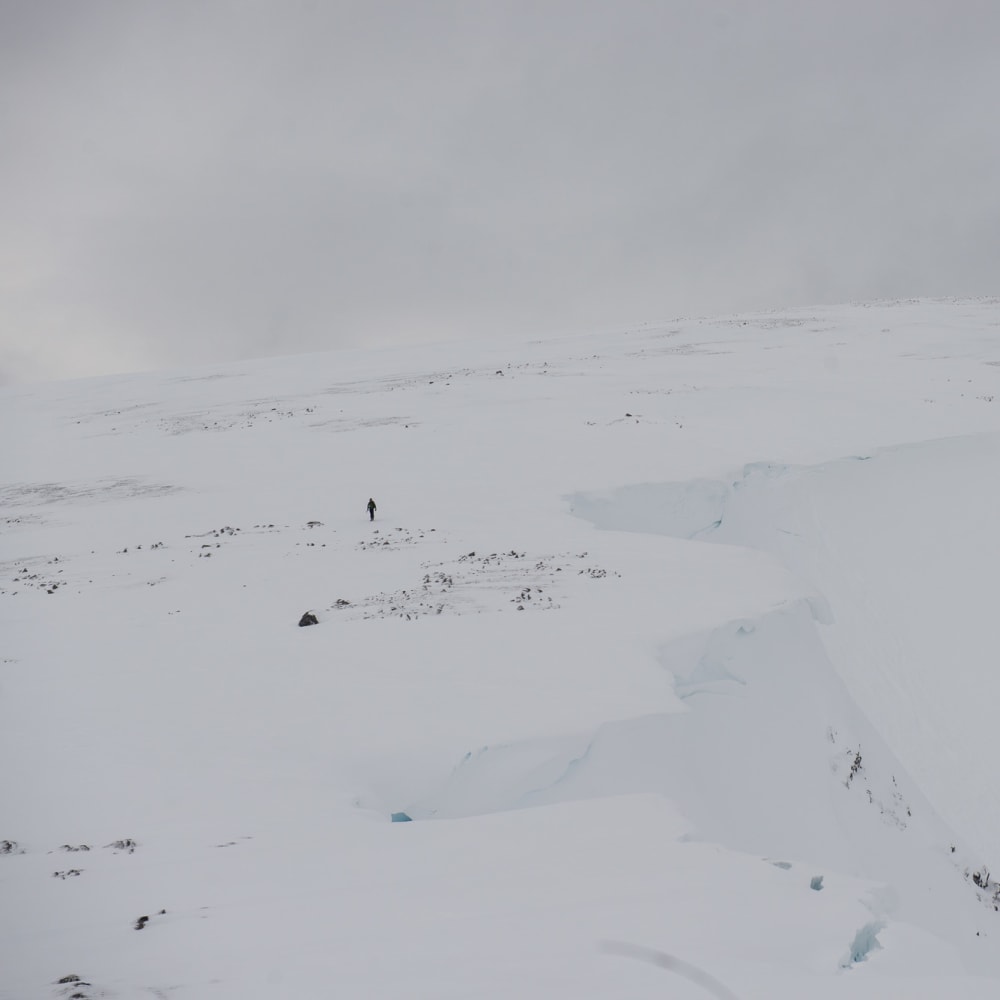 Ed in far distance is a dark spec on an otherwise white mountain.