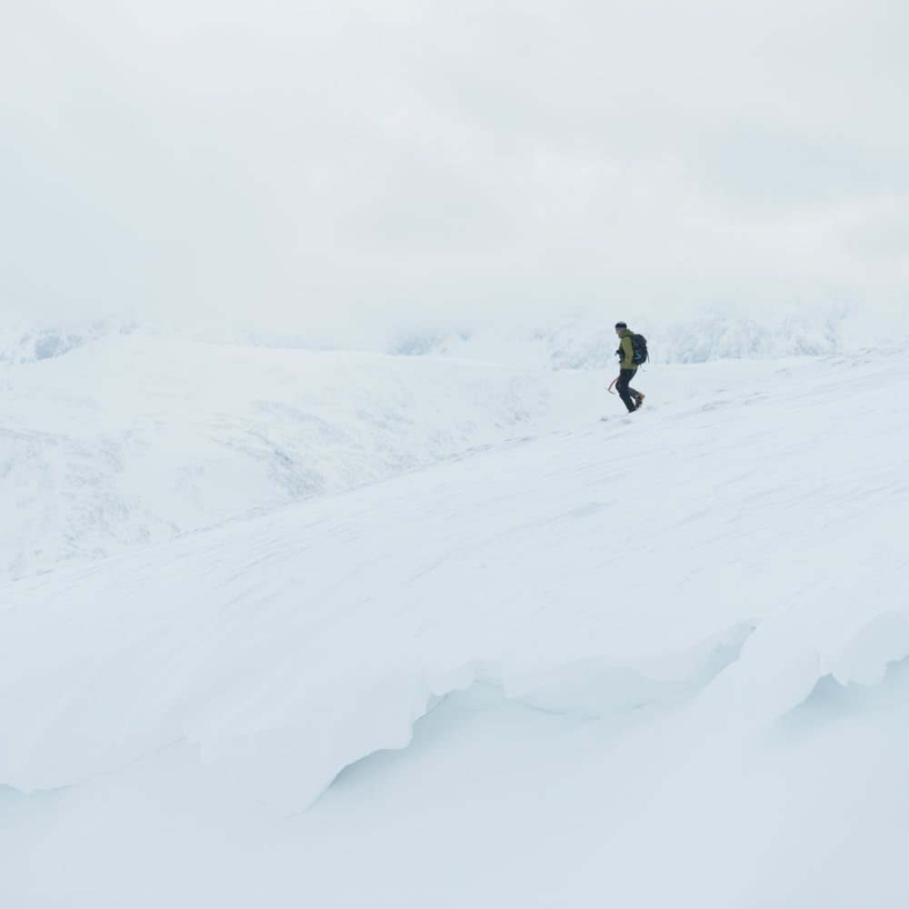 Chris descending a snowy plateau.