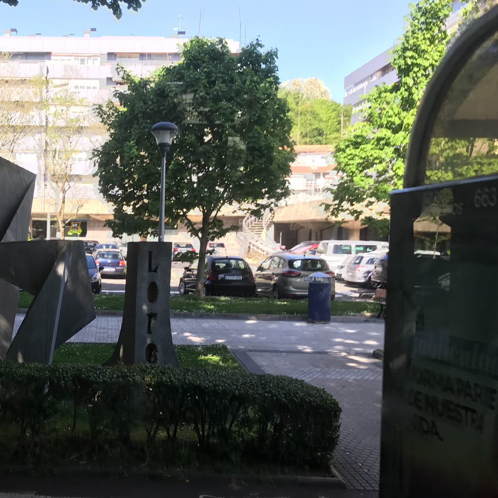 A concrete sculpture at the side of the road. The sculpture resembles origami with lots of folded corners.