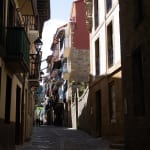 A narrow street in Getaria, with sunlight on one side.