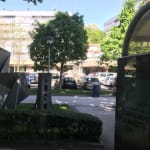 A concrete sculpture at the side of the road. The sculpture resembles origami with lots of folded corners.