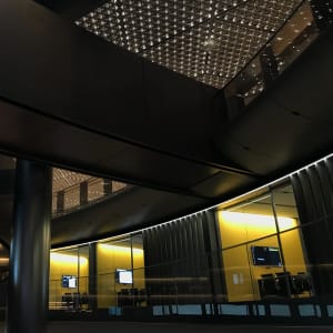 An interior shot of the Bloomberg building. There are walkways overhead.