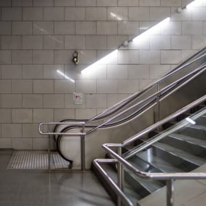 A photo of the base of an escalator in a metro train station.