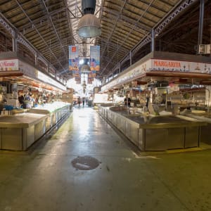 Looking down the centre of a covered food market.