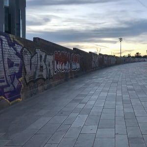 A photo of wide pavement / walkway that rises slightly.