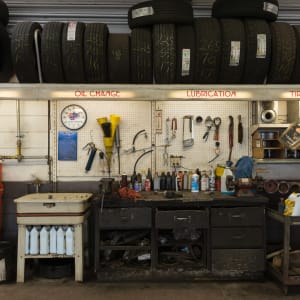 A photo directly facing a workbench inside an automotive garage.