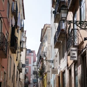 Looking up a narrow street in bright sunlight.
