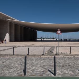 Looking straight-on to the Portugal pavilion. The pavilion has a large suspended roof that curves gently downwards in the centre.