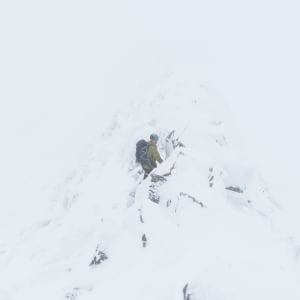 Chris on the CMD Arete. It’s a near whiteout so you can only just see the rock-face in the middle.