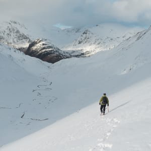 Chris descending in to the bowl of the Ring of Steall. It’s later in the day and the sun is low in the sky. The bowl is already in shadow. There’s a small windy stream at the base of the bowl.