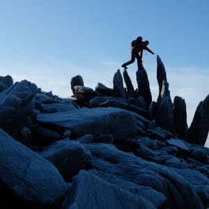 Chris crosses a series of tall rocks pointing straight up in the air like crystals.