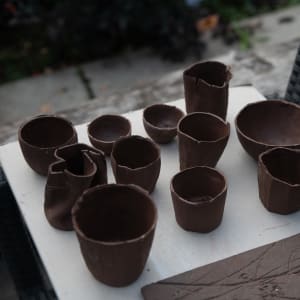 A group of freshly made slip-casts, drying on a table.
