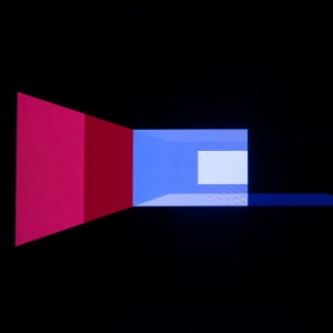 Geometric shapes in blues and pinks on a dark background. Shapes are more on the left than the right. They look almost like a projection of a 3d rendered room.