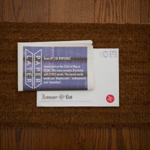 Photo of a PaperLater newspaper on a doormat.
