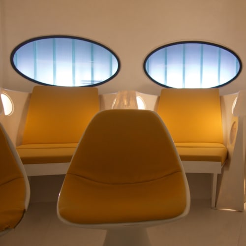 A detail of yellow padded seating inside Futuro house.