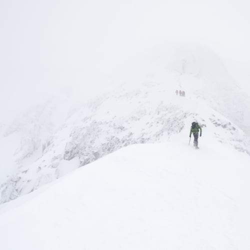 Ed climbing up the side of the Ledge route in very white conditions