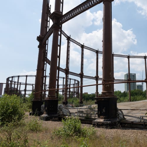 A photo of two gas works, taken near to one. The floor of the dome of the nearest works is visible.