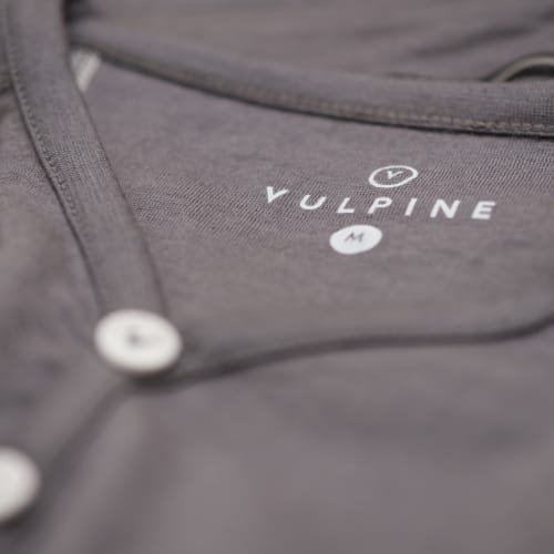 Macro photo of the clothing label in a grey jersey.