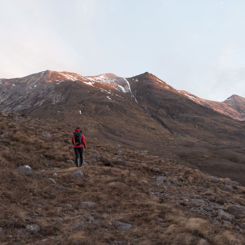 Chris walking away from the camera and towards Beinn Eighe, just at sunrise.