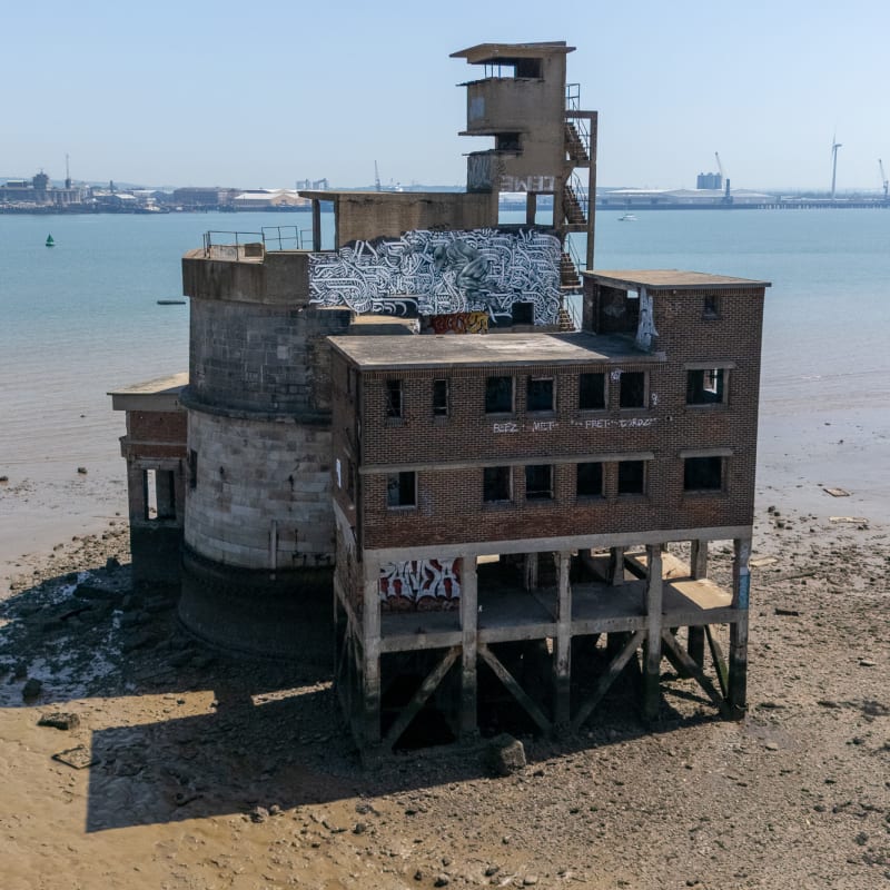 Portrait photo of the exterior of one side of the battery showing a rectangular structure on stilts.