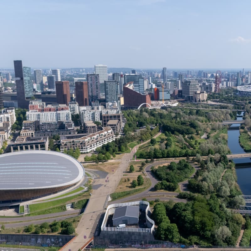 Looking over the olympic park with the velodrome in foreground and stadium in background.
