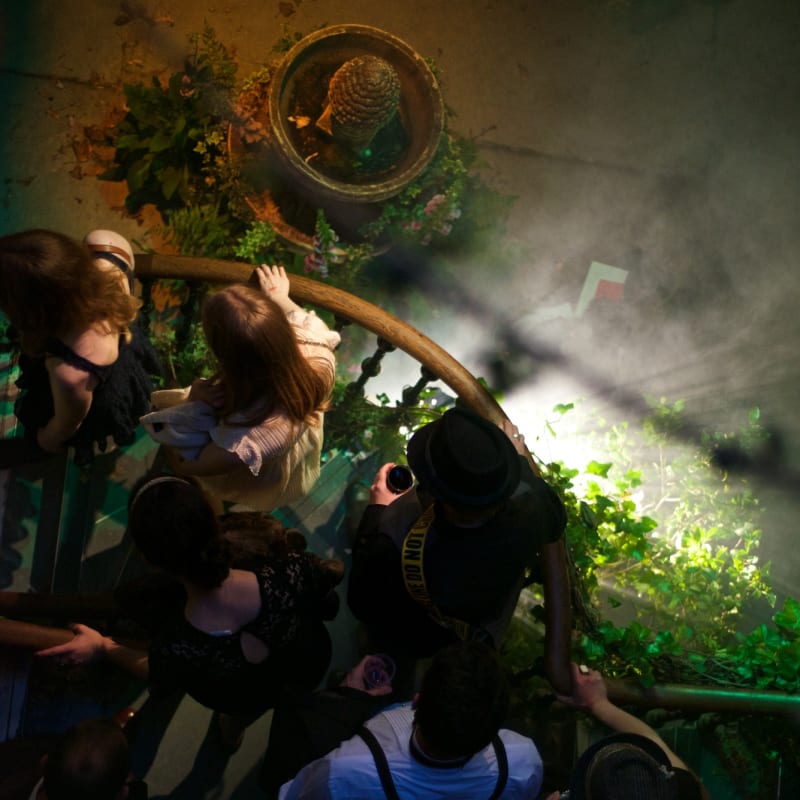 Looking down on a staircase as people descend.