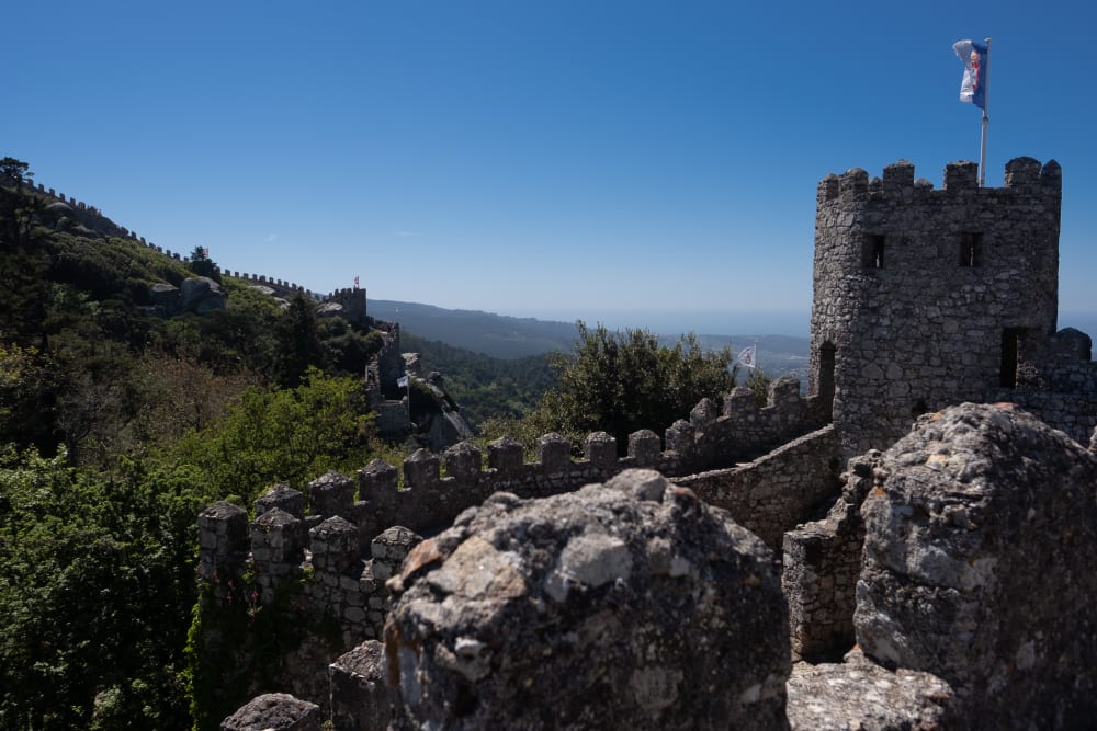 A view of one corner of the Castle of the Moors with fortified walls receding in to the distance.