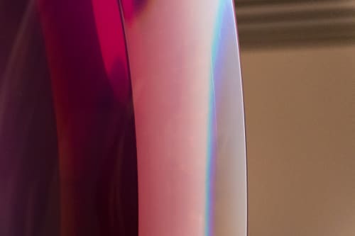 A closeup of a translucent dark red and violet object.