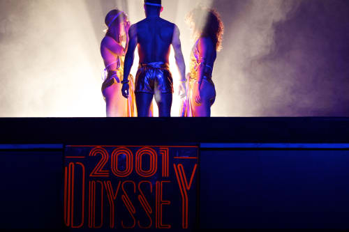 Three silhouetted dancers in smoke.