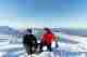 Ed and Chris kneel down with ice axes in hand at the top of Stob Coire an t-Sneachda