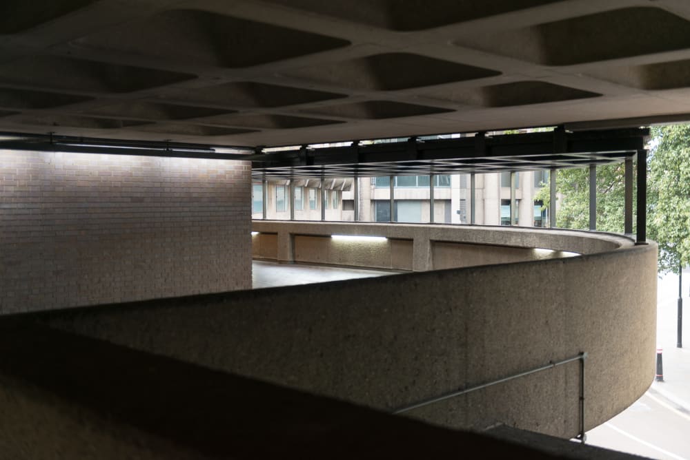 The side of a curved covered walkway in the Barbican.
