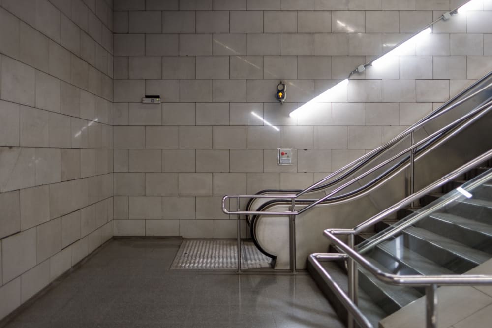 A photo of the base of an escalator in a metro train station.