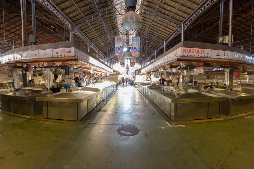 Looking down the centre of a covered food market.