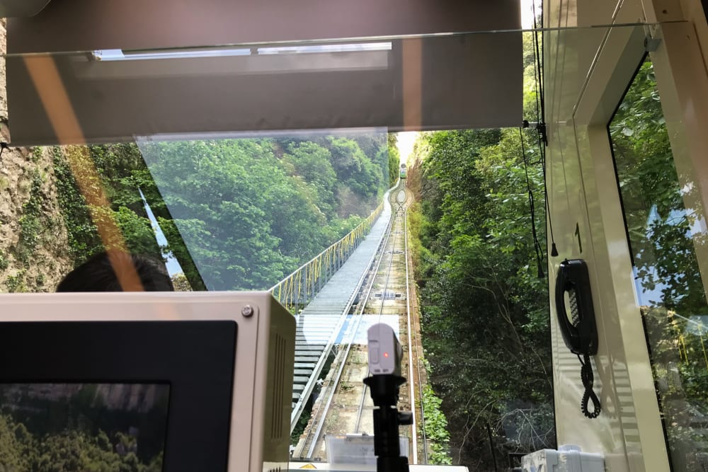 Looking up the tracks of a funicular railway from inside the train car.