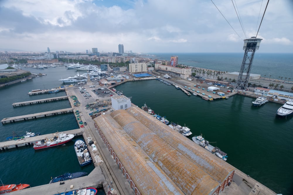 A photo taken from a cable car overlooking a port.