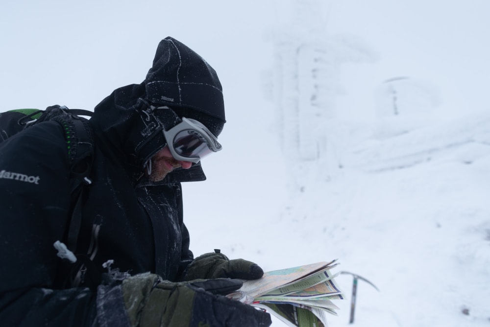 Ed Horsford reading a OS map next to the Cairngorm mountain weather station