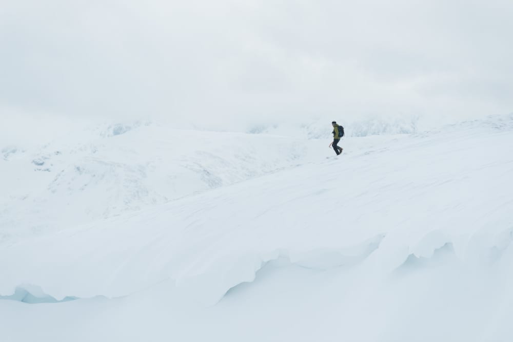 Chris descending a snowy plateau.