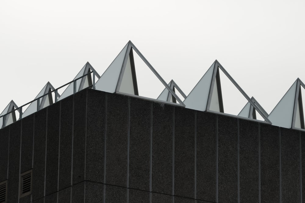 A close shot of the roof of the Hayward gallery. The roof is covered in metal and glass pyramids to capture light.