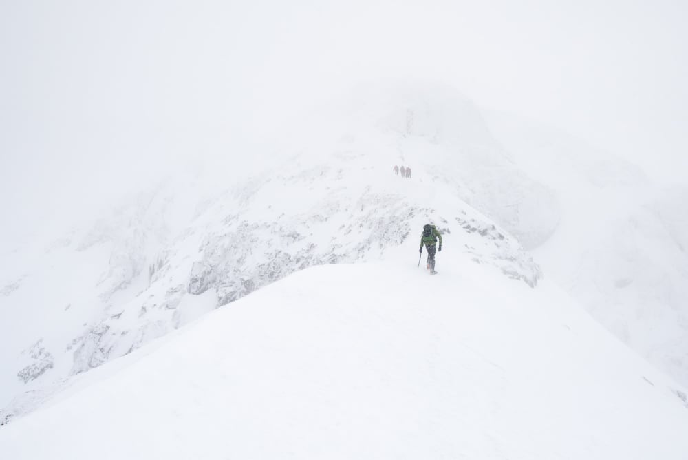 Ed climbing up the side of the Ledge route in very white conditions