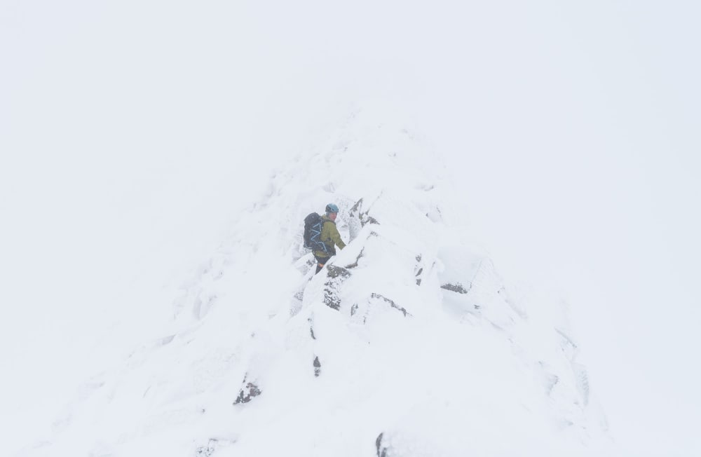 Chris on the CMD Arete. It’s a near whiteout so you can only just see the rock-face in the middle.