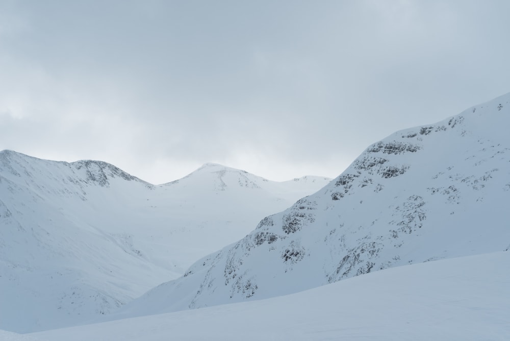 A low contrast view of several snowy ridges.