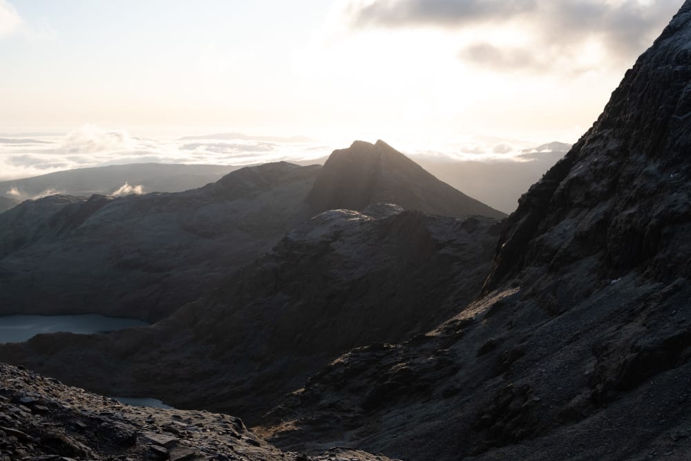 The peak of Ylliwedd seen in the distance in shadow.