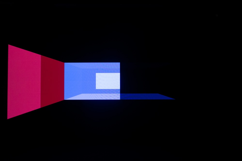 Geometric shapes in blues and pinks on a dark background. Shapes are more on the left than the right. They look almost like a projection of a 3d rendered room.