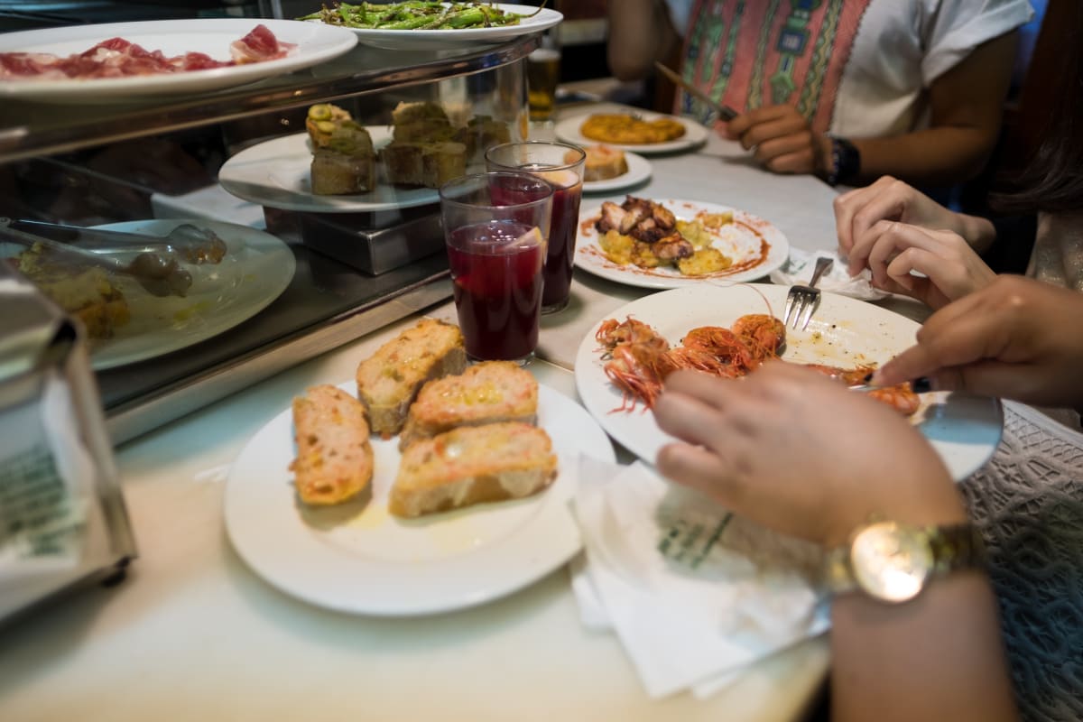 Several plates of tapas being eaten in El Xampanyet.