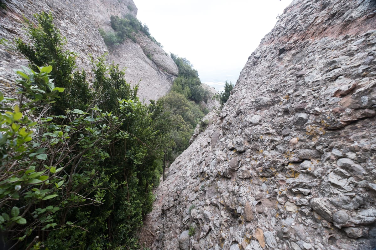 A view down a cut v in two rock faces. Both faces are very steep.